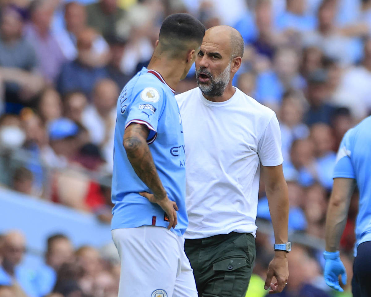 Pep Guardiola (right) pictured speaking to Joao Cancelo during Manchester City's game against Bournemouth in August 2022
